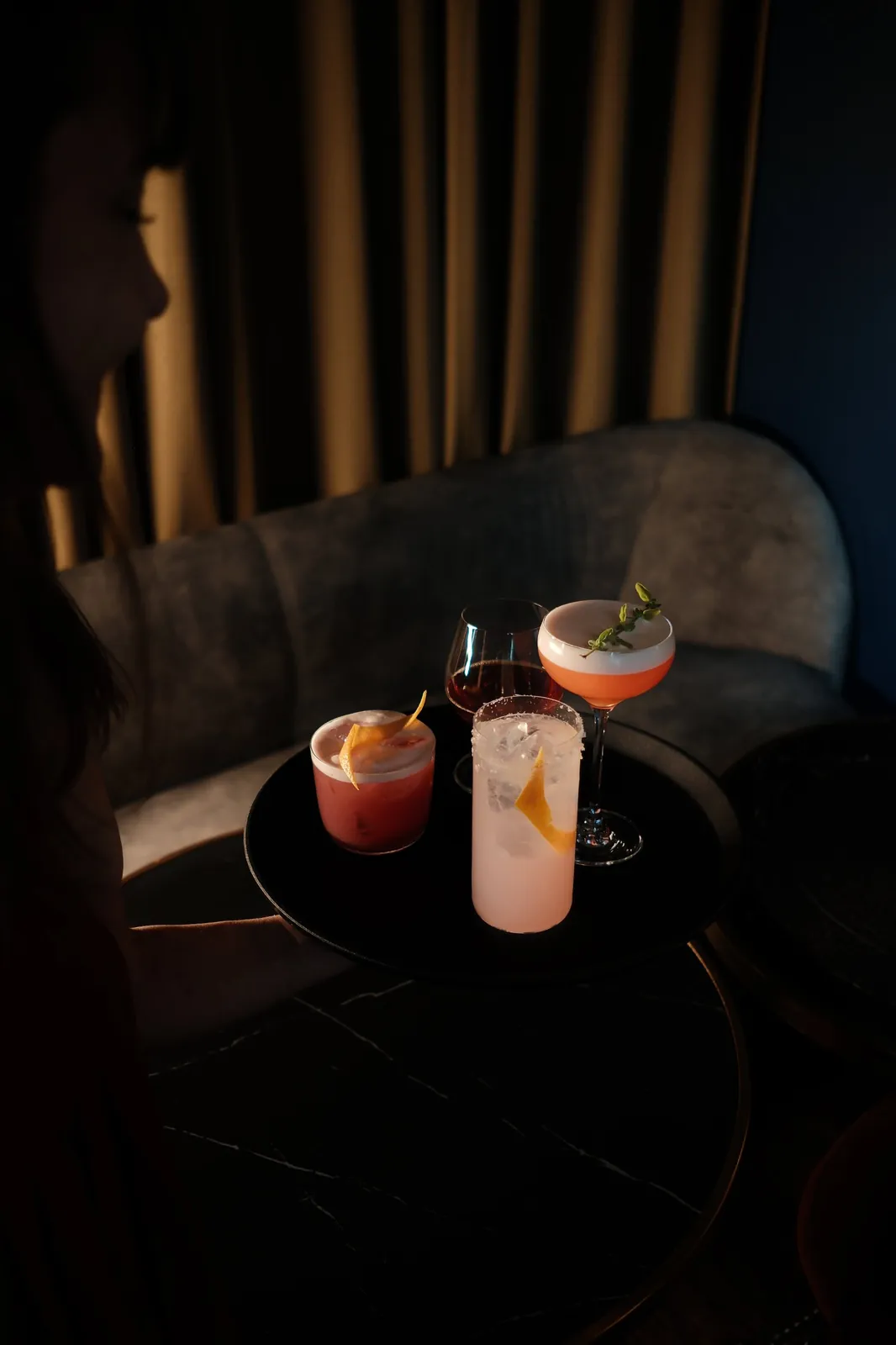 Sazerac, Over the Sun, Mi-to Sour and Smoke & Tide Paloma cocktails on a tray in the Sippers lounge
