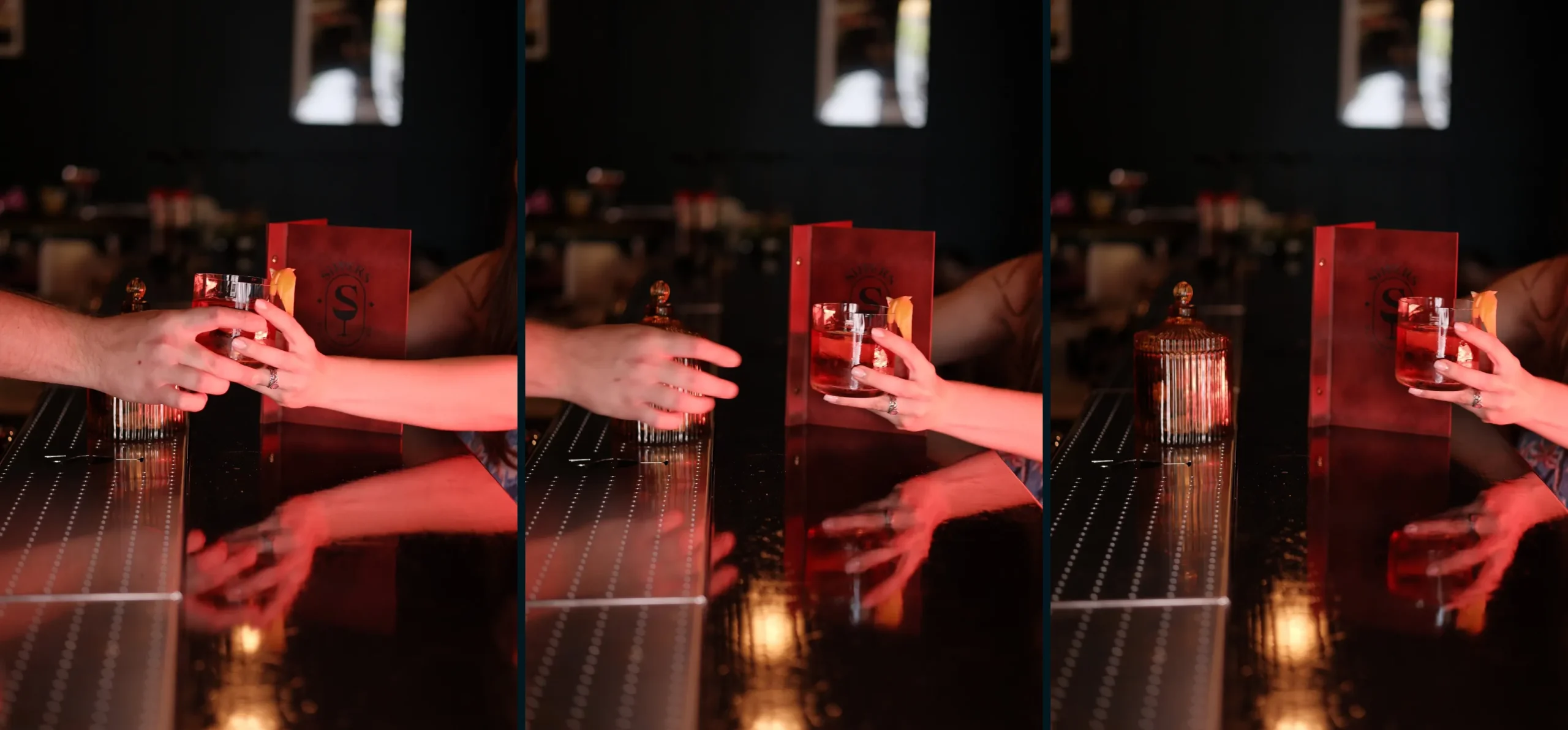 Cocktail being handed across the bar at Sippers cocktail bar in Bucharest Old Town